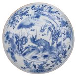 A large Chinese blue and white deep dish, the centre decorated with a kylin, 18thC, H 6 - ø 37 cm