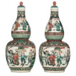 Two Chinese famille verte double gourd vases and covers, decorated with scenes from 'The Romance of