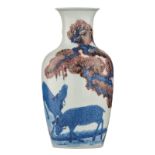 A Chinese Kangxi style underglaze blue and copper-red vase, decorated with two young deer under a pi