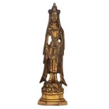 An Oriental gilt bronze female figure, standing on a lotus base, H 15 cm