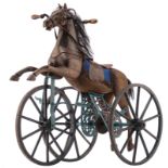 A wooden polychrome painted tricycle toy horse, the manes out of natural horsehair, the mechanic par