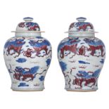 A pair of Chinese cobalt blue and copper-red vases and covers, decorated with kylins, H 49 cm