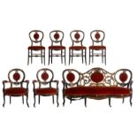 A Napoleon III black lacquered salon set consisting of a settee, two armchairs and four chairs, flor