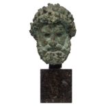 The bust of Zeus, after the Antique, green patinated bronze on a serpentine marble base, H 32 - 50 c