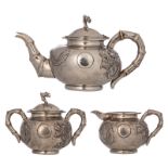 A Chinese three-piece silver tea set with dragon design, marked 'Yok Sang', Shanghai, H 4,5 - W 25,5