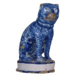 A blue and white earthenware spongeware sculpture of a seated dog, marked G.S 1779, 18thC, H 16 cm