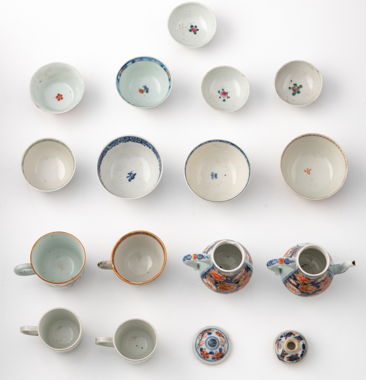 Various famille rose, blue and white, polychrome and Imari cups and saucers, two teapots and covers, - Image 22 of 25