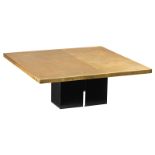 An etched brass coffee table by Meiduer, supported by a black metal base, the top decorated with geo