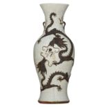 A Chinese relief crackleware vase, decorated with a crane and two dragons, chasing the flaming pearl
