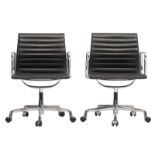 A pair of black leather upholstered aluminium group office chairs, with a chromed swivel base, desig