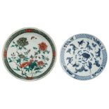 A Chinese famille verte plate, decorated with a butterfly and blossoming flowers, the reverse with d