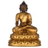 A Chinese bronze and gilt bronze seated Buddha, on a lotus-shaped base, with a six-character mark, Q