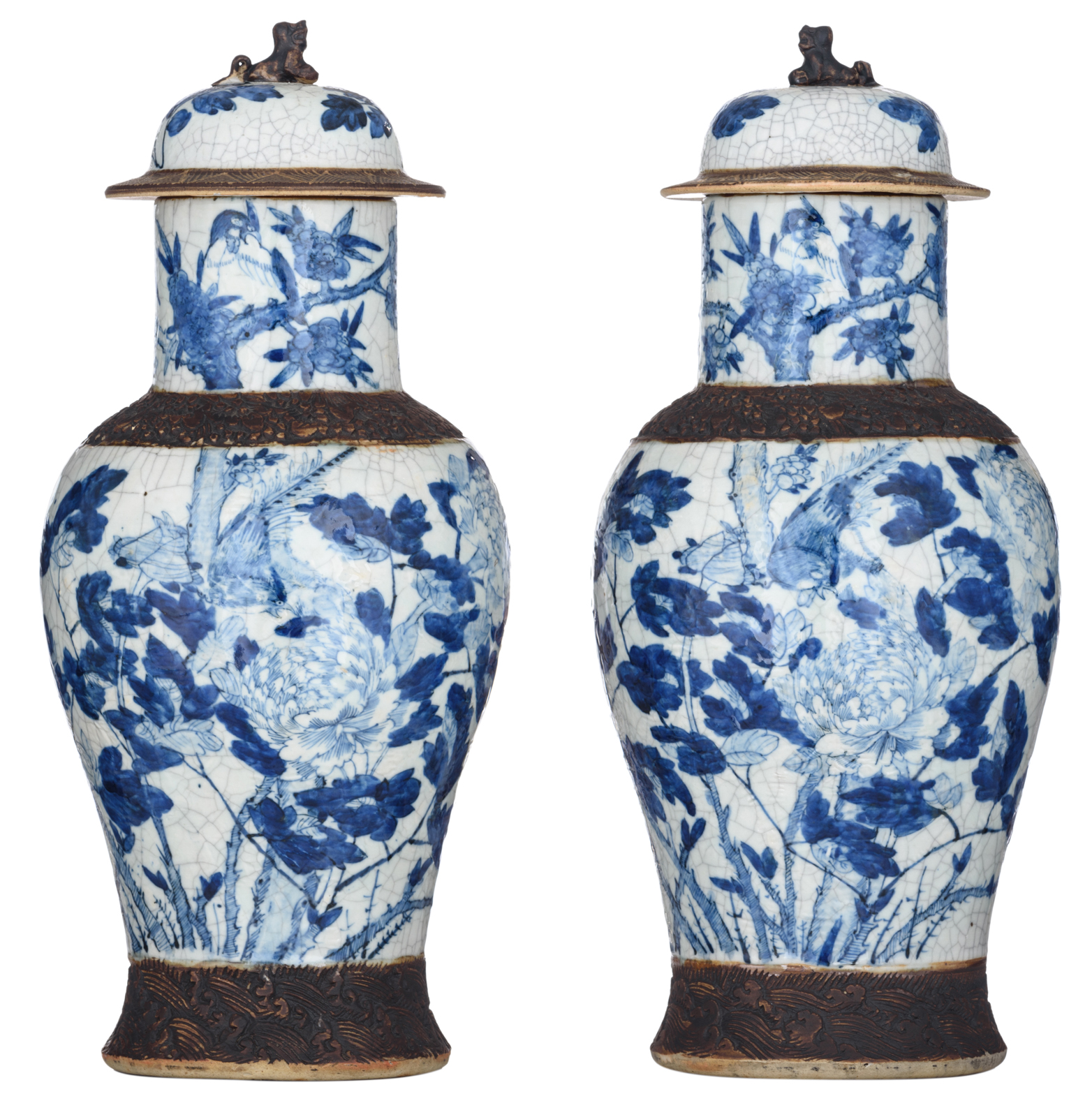 A pair of Chinese blue and white stoneware vases and covers, decorated with flowers and birds, marke