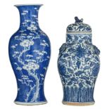 A Chinese blue and white baluster vase, decorated with prunus blossoms; added a ditto covered vase,