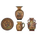 A collection of Italian pottery items by Arno Montopoli, decorated with cold painted dragons and dee