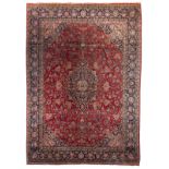 A large Oriental floral decorated woollen rug, 440,5 x 307 cm