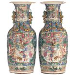 A pair of large and imposing Chinese blue ground famille rose relief decorated vases, the roundels w