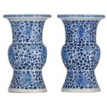 A pair of Chinese blue and white floral decorated Gu vases, 19thC, H 40,5 cm