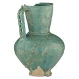 A turquoise glazed epigraphic Seljuk jug with engraved decoration, Persia, ca. 1200, repaired, H 20,