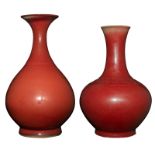 A Chinese porcelain sang de beuf bottle vase and a ditto pear-shaped vase, H 33,5 - 36 cm