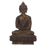 An Oriental gilt decorated bronze figure, depicting a meditating seated Buddha, on a lotus base, H 2