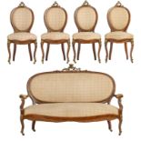 A Rococo style mahogany veneered salon set, with floral decorated upholstery and gilt bronze mounts,
