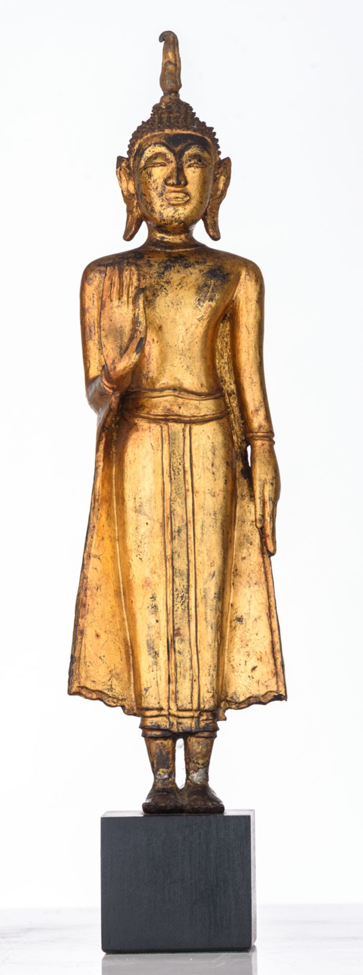 An Oriental gilt decorated bronze figure, depicting a standing Buddha, the raised right hand in abha - Image 2 of 5