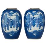 A pair of Chinese blue and white ginger jars, the panels with flowers and animated scenes with figur