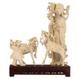 A Chinese ivory group depicting a scholar with a dragon on his shoulder and wearing a miniature goat