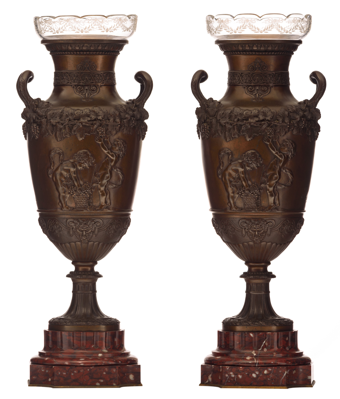 A pair of Neoclassical patinated bronze flower vases on a rouge royal marble base and with glass sha