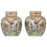 A pair of Chinese crackleware ground Nanking ginger jars and covers, decorated with flowers and bird