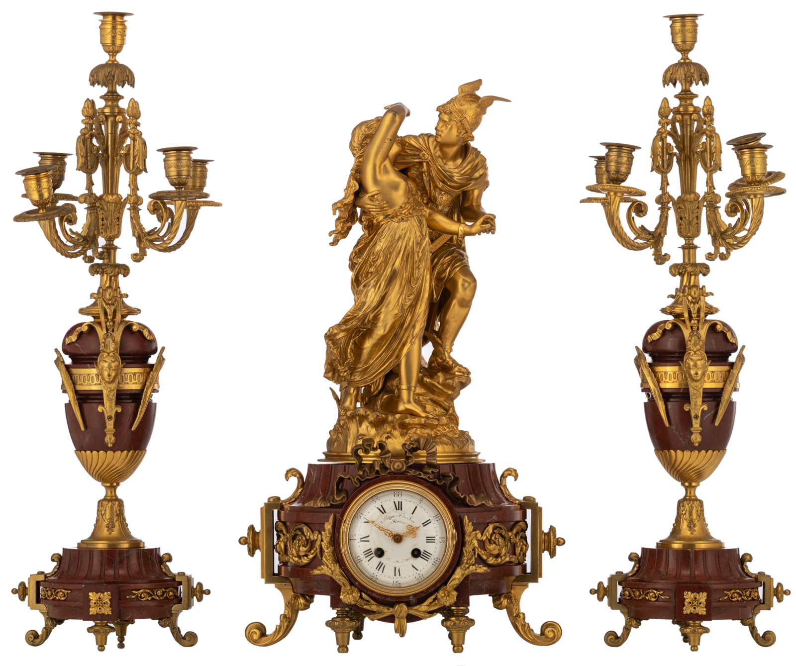 A Neoclassical three-piece rouge Napoleon marble garniture, consisting of a pair of vase-shaped cand