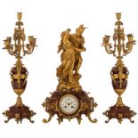 A Neoclassical three-piece rouge Napoleon marble garniture, consisting of a pair of vase-shaped cand