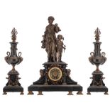 A three-piece noir Belge marble garniture, consisting of a pair of vase-shaped candelabras and a man