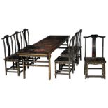 An imposing black laquered dining furniture set, consisting of a large table and seven chairs, the t