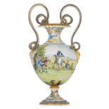 An imposing floral decorated Renaissance inspiredmajolica vase, with double snake-shaped handles and
