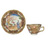 A Chinese famille rose and gilt export porcelain cup and saucer, decorated with animated scenes, 18t
