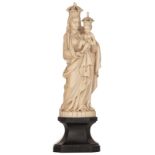 A finely carved ivory sculpture of the Holy Mother and Child, on an ebonised wooden base, 19thC, pro