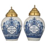 A pair of blue and white decorated Delftware tobacco jars, inscribed with 'Pompedoer' and 'Marteniek