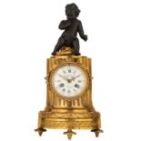 A French column-shaped gilt bronze mantle clock, with a patinated bronze amor on top, the dial marke