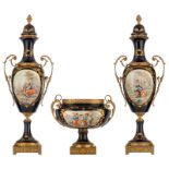 A three-piece bleu royale ground garniture set in the Sèvres manner, with gilt bronze mounts, the ro