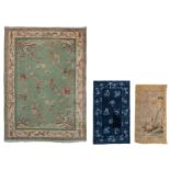 Three Chinese woollen rugs, one decorated with antiquities, 235 x 167 cm, one decorated with floral