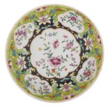 A Chinese lime ground famille rose floral decorated charger, H 7,5 - ø 40 cm