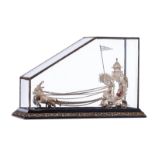 An Oriental silver filigree horse-drawn carriage, in a glass case with an Art Nouveau decorated base