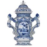A blue and white Dutch Delftware covered vase with twin handles in the form of winged therms, the ro