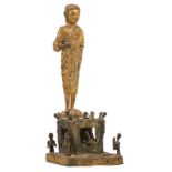 A South-East Asian gilt bronze standing Buddha, on a bronze base depicting a scene from the Tantric