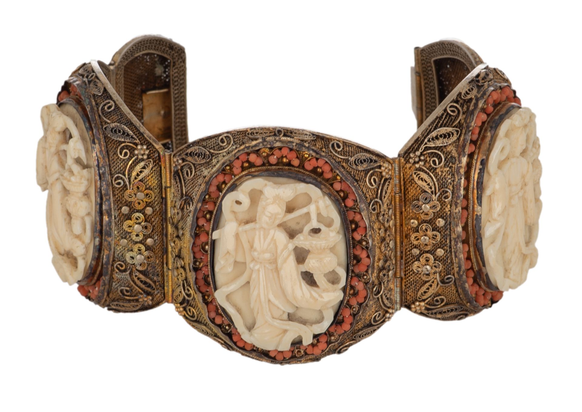 An Oriental filigree gilt silver bracelet set with basso-relievo cut ivory plaques surrounded by cor