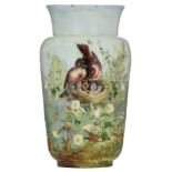 A French earthenware vase with relief painted decoration, depicting birds feeding their chicks in a
