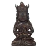 A Sino-Tibetan seated bronze Buddha with traces of polychromy, the hands in namaskara mudra, H 21,5