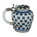 A Japanese Arita porcelain mustard pot with a period silver mount, studded with gilt painted flower